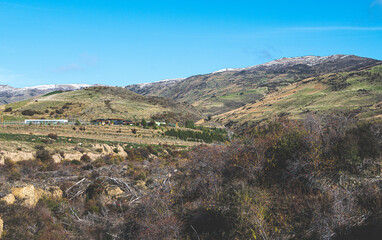Fototapeta premium Bannockburn sluicings scenic reserve new zealand cromwell blue sky rock formations clay cliffs beautiful landscape grey gravel