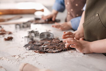 Cooking recipe. Little children cutting cookie dough with cutters at table indoors, closeup