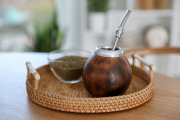 Traditional yerba mate tea on wooden table indoors, closeup