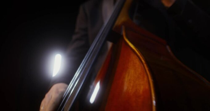 Inspiring cello playing on the theater stage. A man performs in a theater