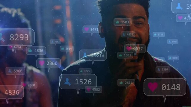 Singer gripping microphone on music stage in haze and spotlights, showing floating reaction icons