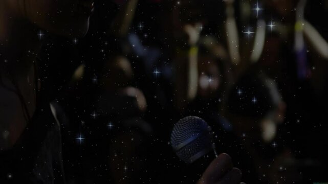 female singer wearing headphones singing into mic in dark music studio, showing starfield overlay