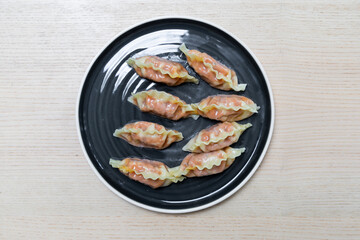 A plate of eight dumplings.