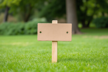 wooden sign in the middle of a field of green grass