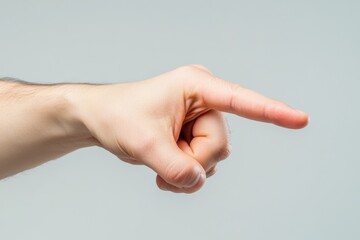 Male hand pointing to the right against a neutral backdrop.