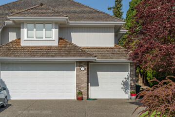 Garage door in luxury house with trees and nice landscape in Spring in Vancouver, Canada, North...
