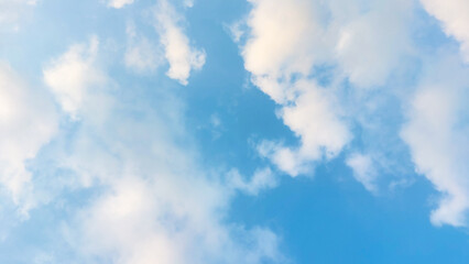 Clear blue sky with fluffy white clouds perfect for aesthetic background