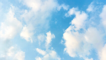 Soft white clouds floating in a vibrant blue sky