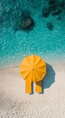 Drone view of yellow umbrella and sunbed on empty beach with turquoise water gradient, vertical format