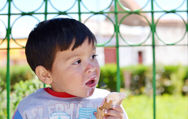 Little latin boy eating ice cream.