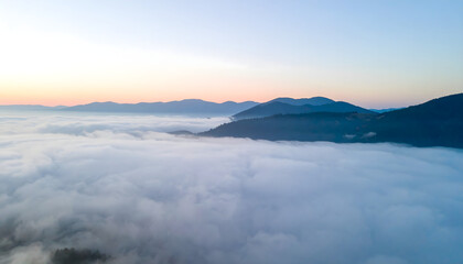 Obraz premium Majestic Sunrise over Mountain Range Sea of Clouds Aerial View