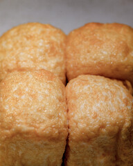 A close up of four golden brown pastries
