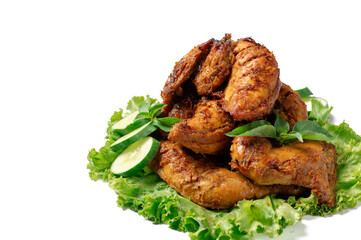 A plate of chicken with green lettuce on top