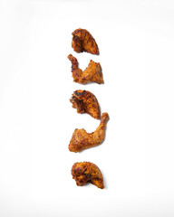 A row of chicken wings are lined up on a white background