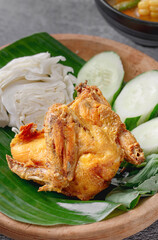 A plate of fried chicken with a side of vegetables