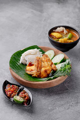 A plate of food with a bowl of soup and a bowl of vegetables