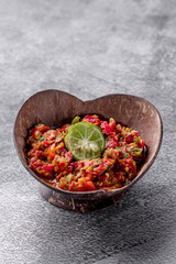 A bowl of food with a lime on top