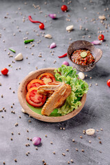 A bowl of food with chicken and lettuce on top of a plate