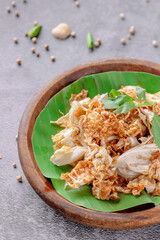 A bowl of food with a green leaf on top