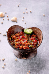 A bowl of food with a lime on top