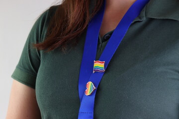 Red hair lesbian woman working and wearing pins with the lgbt flag symbol representing the lgbt...