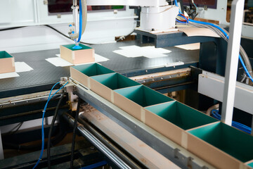 Robotic precision in box manufacturing process enhances efficiency in a modern production facility