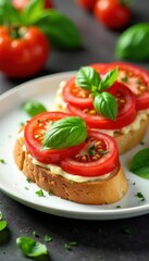 Sliced tomatoes, basil, garlic bruschetta on white plate, Italian food, dish