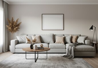 Interior of a living room with a large gray couch and a round coffee table in the center of the room
