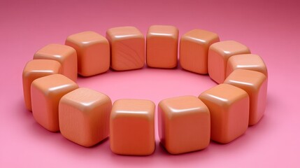 Fototapeta premium A circle of light peach colored wooden blocks arranged on a pink background Perfect for backgrounds and textures