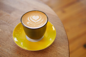 Coffee served in a stylish cup on a wooden table