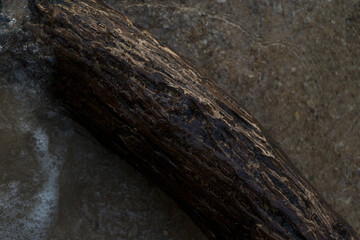 Fresh water flows over natural rocks, cascading into the flowing river in a vibrant summer landscape
