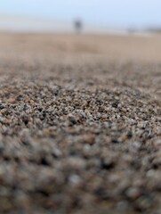 Depth Effect Beach Scene with Sand and Blur Ocean and People