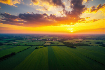 view of a green field with a sunset in the background