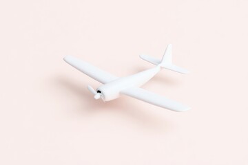 Simple white airplane toy on pastel background