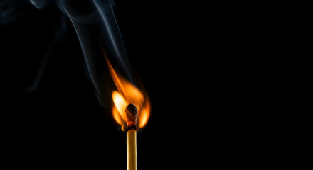 Single Matchstick Burning Brightly Against a Dark Background Igniting with Smoke and Flame