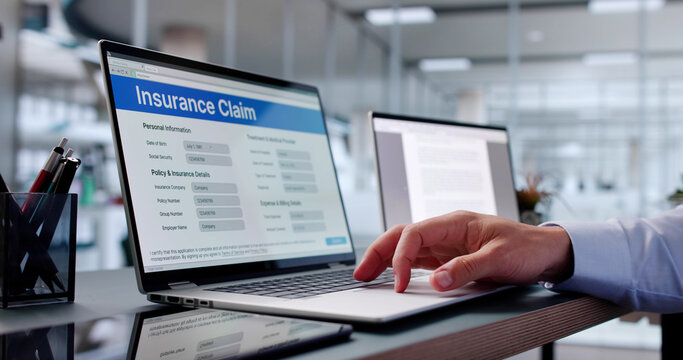 Close-up Of Person Hand Over Insurance Claim