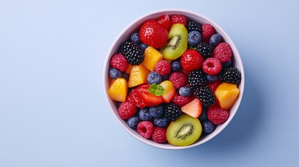 Colorful fruit salad in a bowl, vibrant berries and citrus slices, perfect for healthy snacks or summer picnics.