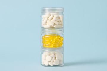 Vitamins and supplements in clear jars against a blue background