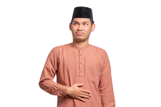 Portrait of Asian Muslim man keep hands on the stomach feeling hungry and want to eat delicious isolated on transparent background