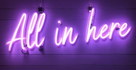 Obraz premium Bright purple neon sign displays text All in here against wood paneling. Simple, modern aesthetic. Inviting message.