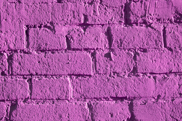 Fragment of brickwork, close-up. Brick wall, close-up. Potholes and defects in a brick wall, flat layout. Cracks and defects in bricks on a wall, color fantasy.