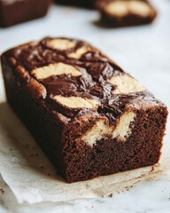 Delicious chocolate cake with vanilla cream cheese swirl on parchment paper a tempting dessert baked treat homemade with rich flavor and comforting indulgence