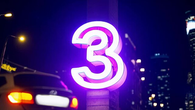 the camera pans across a neon &ldquo;3&rdquo; under a spotlight