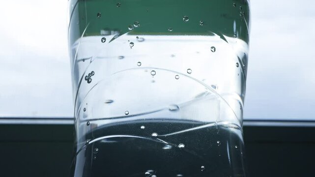 Closeup Blurred Shooting with Bubbles from a Botle with Accidulated Sweet and Freh Drink.
