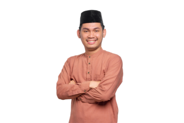 Smiling young Asian Muslim man crossed arms and looking confident isolated on transparent background