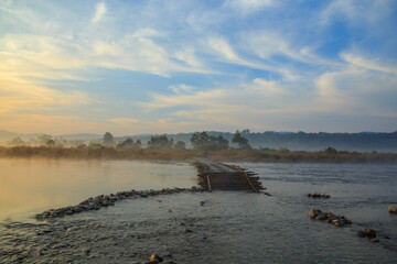 Wooden bridge over a river in Jim Corbett National Park (India). A landscape shot taken on a winter...