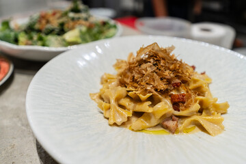 Tagliatelle pasta topped with crispy fried onions