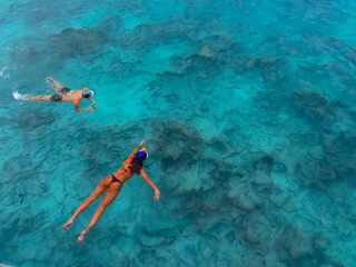 Man and woman snorkeling in a house reef of an island in Maldives © Sandipan
