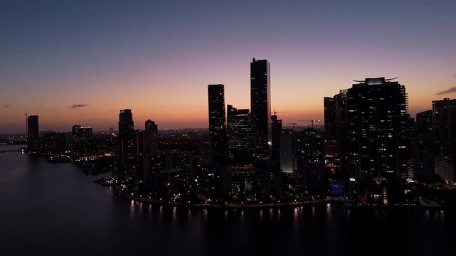 Modern Skyscrapers on the coast of Miami in dusk Illuminated by colorful Sunset Light
