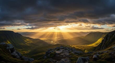 Rays of sun burst through dramatic clouds over a vast valley and mountain range, a stunning sunset landscape. Nature background for travel concept or relaxation.